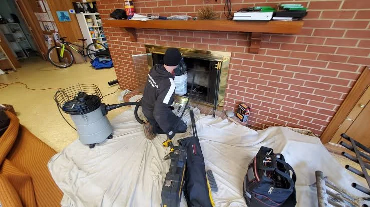 Fireplace maintenance with protective floor sheets and cleaning equipment